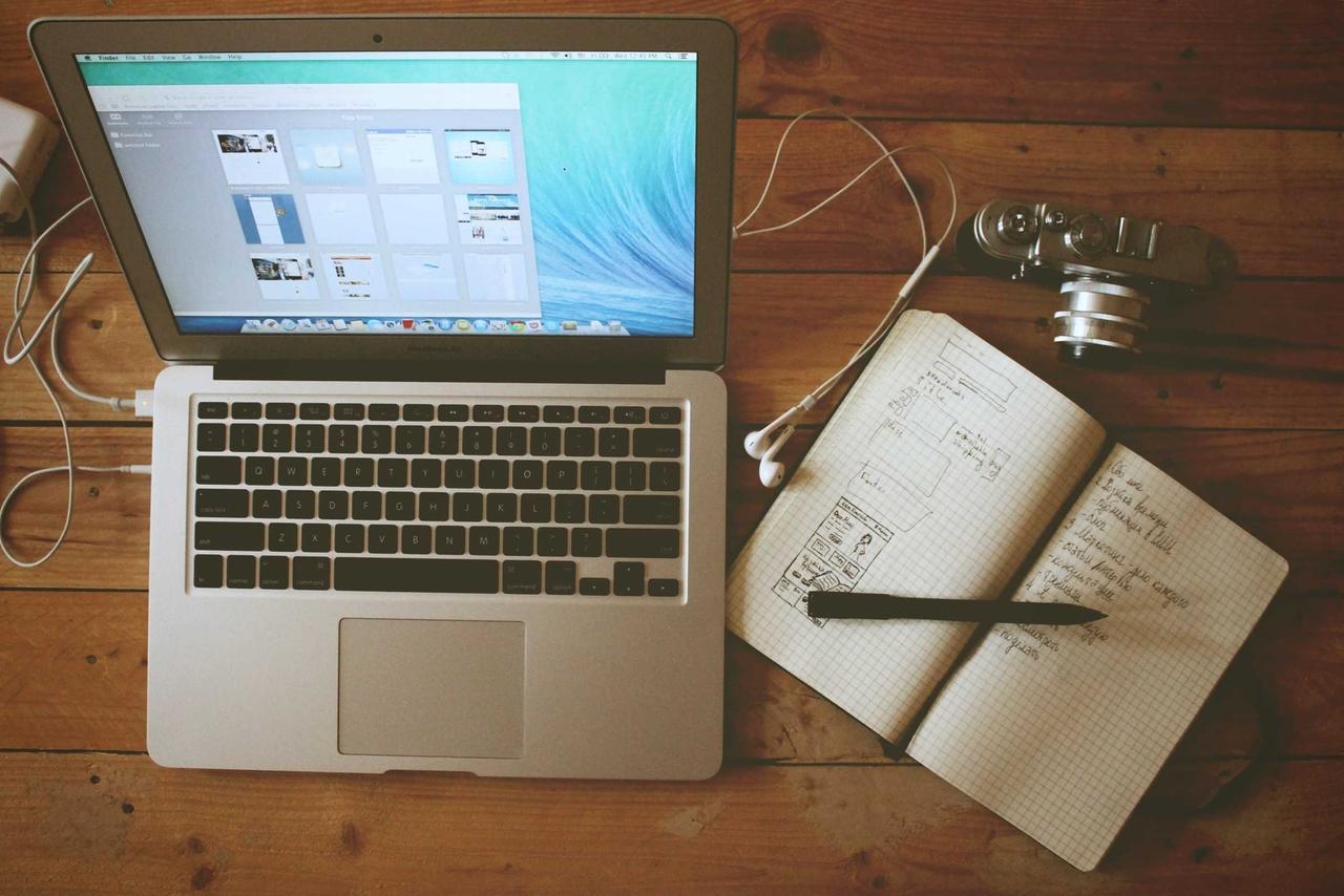A laptop on a desk in a dim office